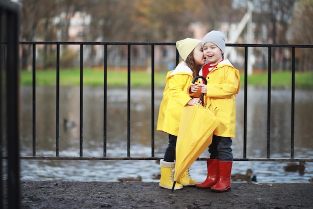 Children walk in the autumn park in the fall