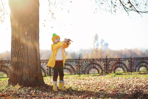 Children walk in the autumn park in the fall