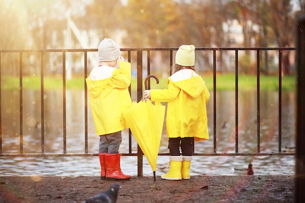 Children walk in the autumn park in the fall