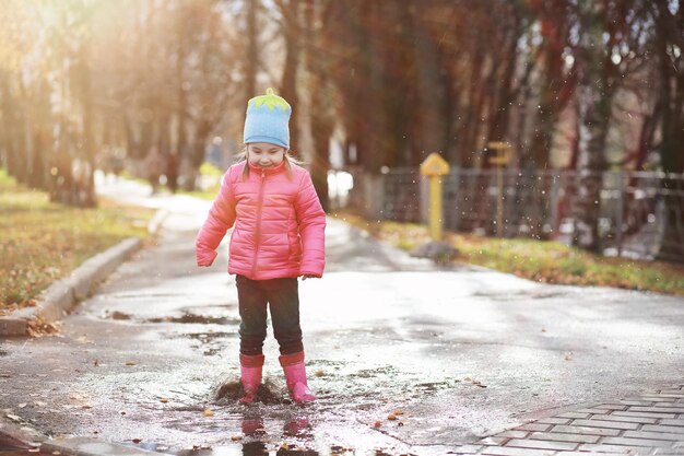 Children walk in the autumn park in the fallxA