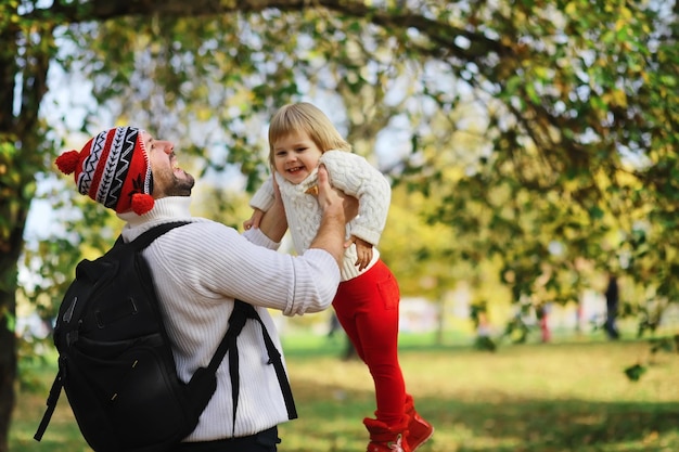 Children for a walk in the autumn park Leaf fall in the park Family Fall Happiness