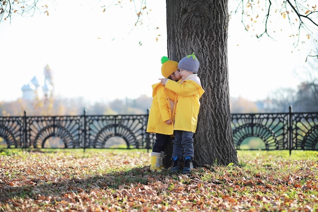 Children walk in the autumn park