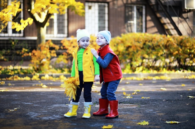 Children walk in the autumn park