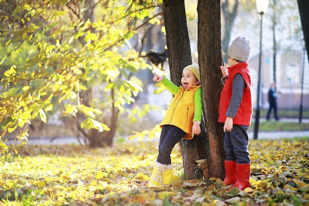 Children walk in the autumn park