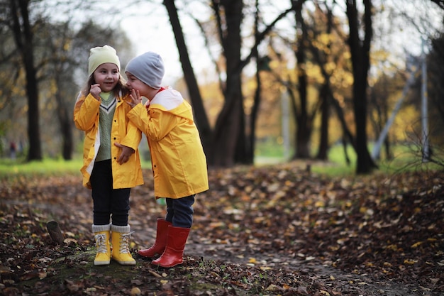 Children walk in the autumn park