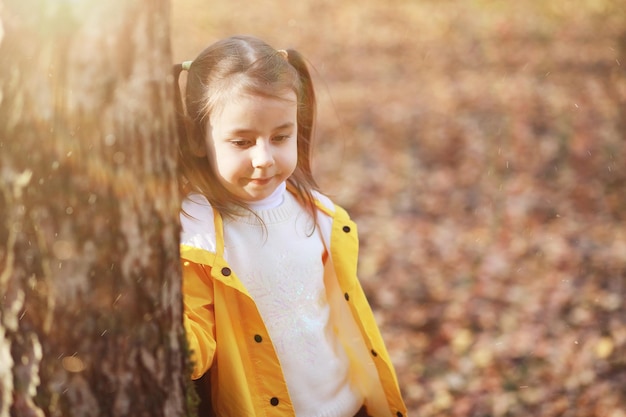 Children walk in the autumn park