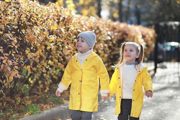 Children walk in the autumn park