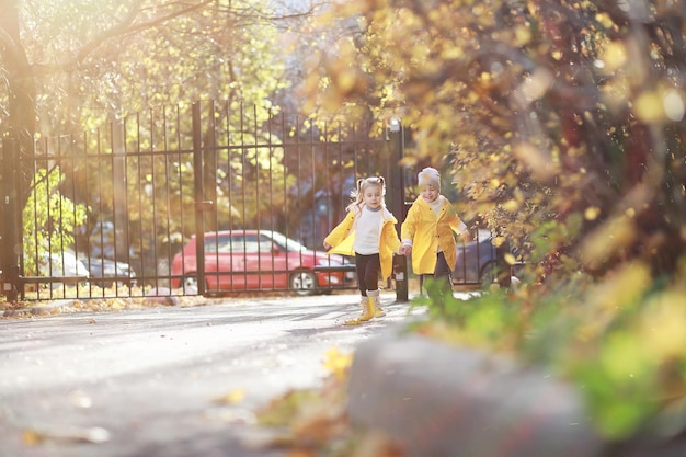 Children walk in the autumn park