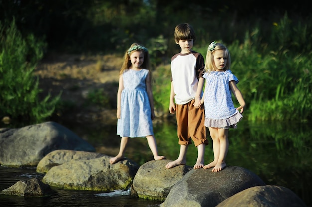 Children walk in the summer in nature Child on a sunny spring morning in the park Traveling with children