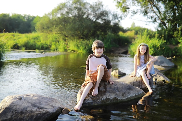 Children walk in the summer in nature Child on a sunny spring morning in the park Traveling with children