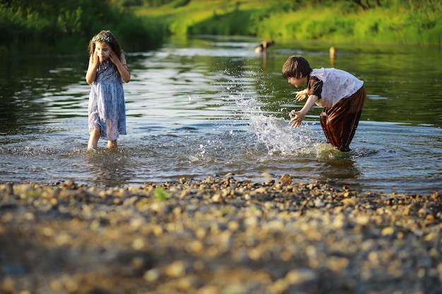 Children walk in the summer in nature Child on a sunny spring morning in the park Traveling with children