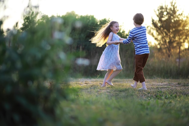 Children walk in the summer in nature Child on a sunny spring morning in the park Traveling with children