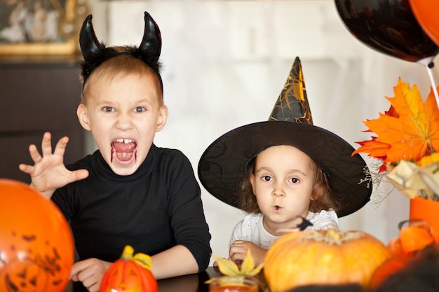 Children in witch and devil costumes for Halloween