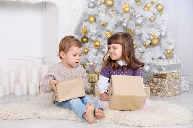 Children with gifts under the Christmas tree