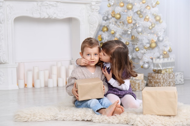 Children with gifts under the Christmas tree