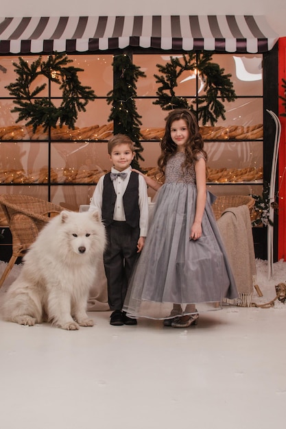 Children with a Samoyed dog New Year