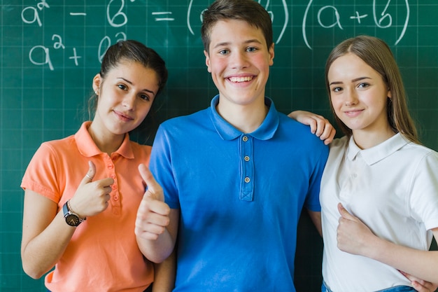 Children with thumbs up in maths class