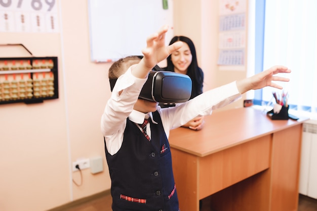 Children with virtual reality glasses are in the school office