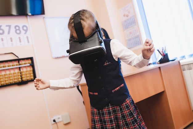 Children with virtual reality glasses are in the school office