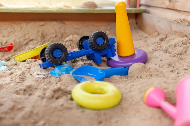 Children39s wooden sandbox with various toys for the game