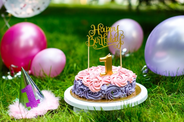 Childrens cake for a girl on first birthday in summer park