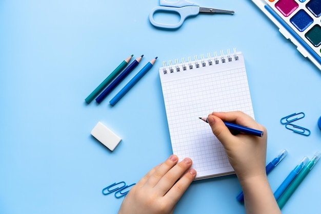 Childrens hands in front of a blank sheet top view space for text creativity