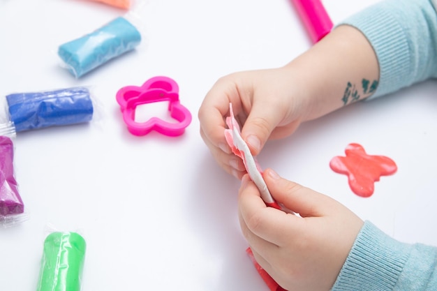 Childrens hands play dough for children's creativity. Board game for the development of fine motor skills