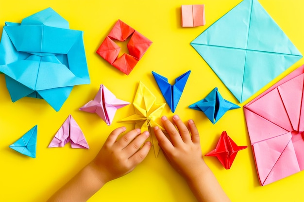 Photo childs hands holding origami birds on yellow background