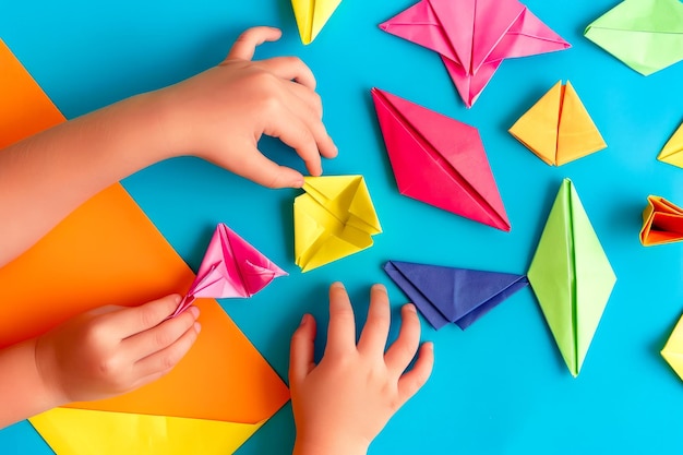 Photo childs hands reaching for origami pieces on blue background