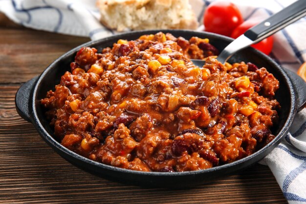 Chili con carne in frying pan on table