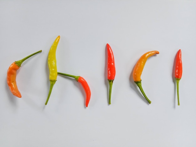 Photo chili peppers. red hot chili peppers. colorful chili peppers isolated in white. top view.