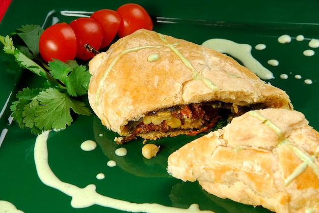 chili stuffed with meat and vegetables in puff pastry with cherry tomato slices, mexican food