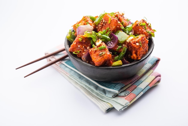 Photo chilli paneer dry is made using cottage cheese, indo chinese food