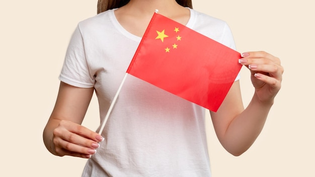 China flag Communism society Woman in white holding fivestarred red official national republic symbol isolated on blur beige background World market Global trade