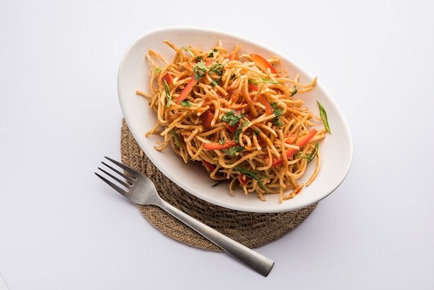 Chinese Bhel is a spicy indo-chinese recipe, served in a bowl. selective focus