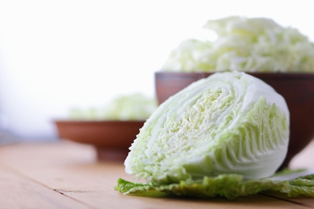 Chinese cabbage salad preparation Fresh chinese cabbage on a wooden background Sliced chinese cabbage Organic vegetables Closeup