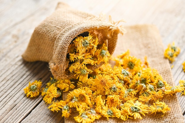 Chinese chrysanthemum flower tea Dried chrysanthemum buds for herbal tea on wooden background dry chrysanthemum flower yellow