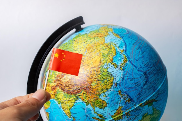 Chinese flag on background of globe with map