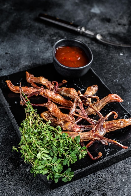 Chinese food dip fried duck tongue Black background Top view