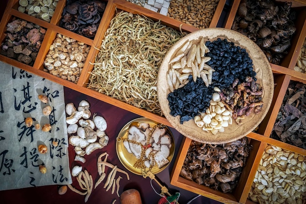 Chinese herbal medicine and flower tea on wooden