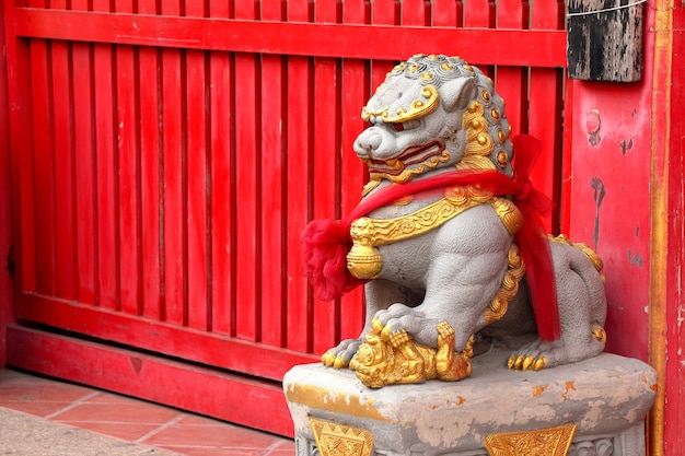 Chinese lion statue in front of chinese temple