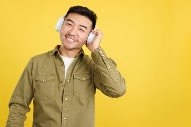 Chinese man listening to music with headphones and a mobile