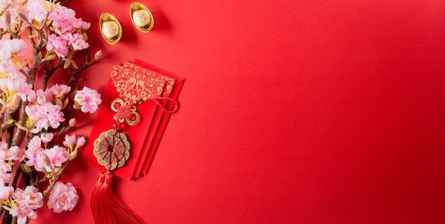 Chinese new year decorations made from red packet orange and gold ingots or golden lump on a red background Chinese characters FU in the article refer to fortune good luck wealth money flow