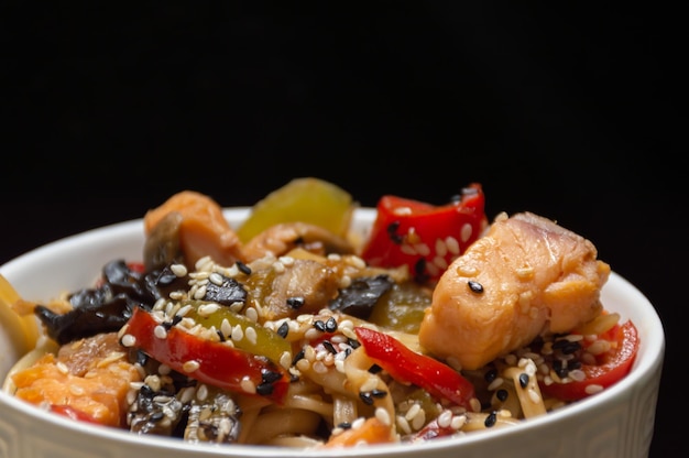 Chinese noodles with red fish and vegetables