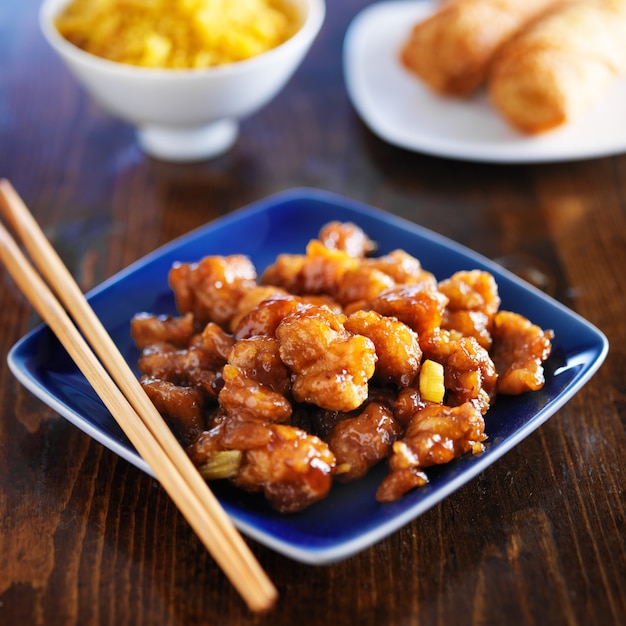 Chinese orange chicken on a blue plate