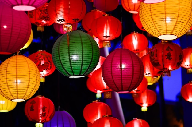 Chinese-style lanterns of various colors are set together, and are lit up at night.