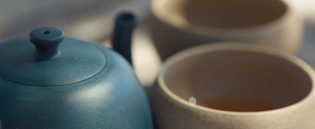 Chinese tea ceremony Ceramic teapot made of clay and bowls on a wooden background