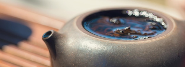 Chinese tea ceremony Ceramic teapot made of clay and bowls on a wooden background