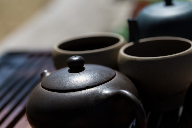 Chinese tea ceremony Ceramic teapot made of clay and bowls on a wooden background