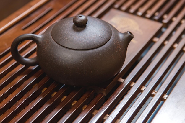 Chinese tea ceremony Ceramic teapot made of clay and bowls on a wooden background